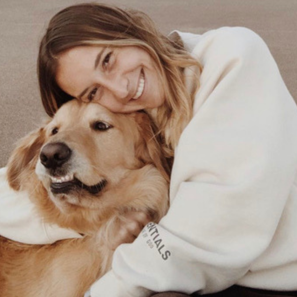 Gabby Seiler smiling and hugging her dog.