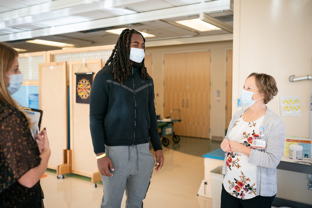 Patrick Jones speaks with 2 others while touring Gillette Children's Specialty Hospital