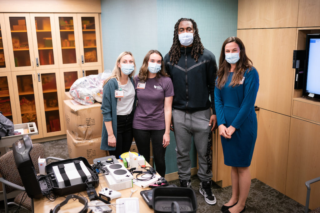 Patrick Jones poses with 3 others while touring Gillette Children's Specialty Hospital