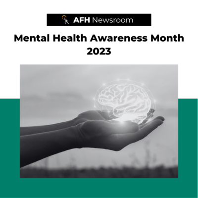 Text and logo graphic on green background that reads "AFH Newsroom, Mental Health Awareness Month 2023" with a photo of hands holding a glowing mind