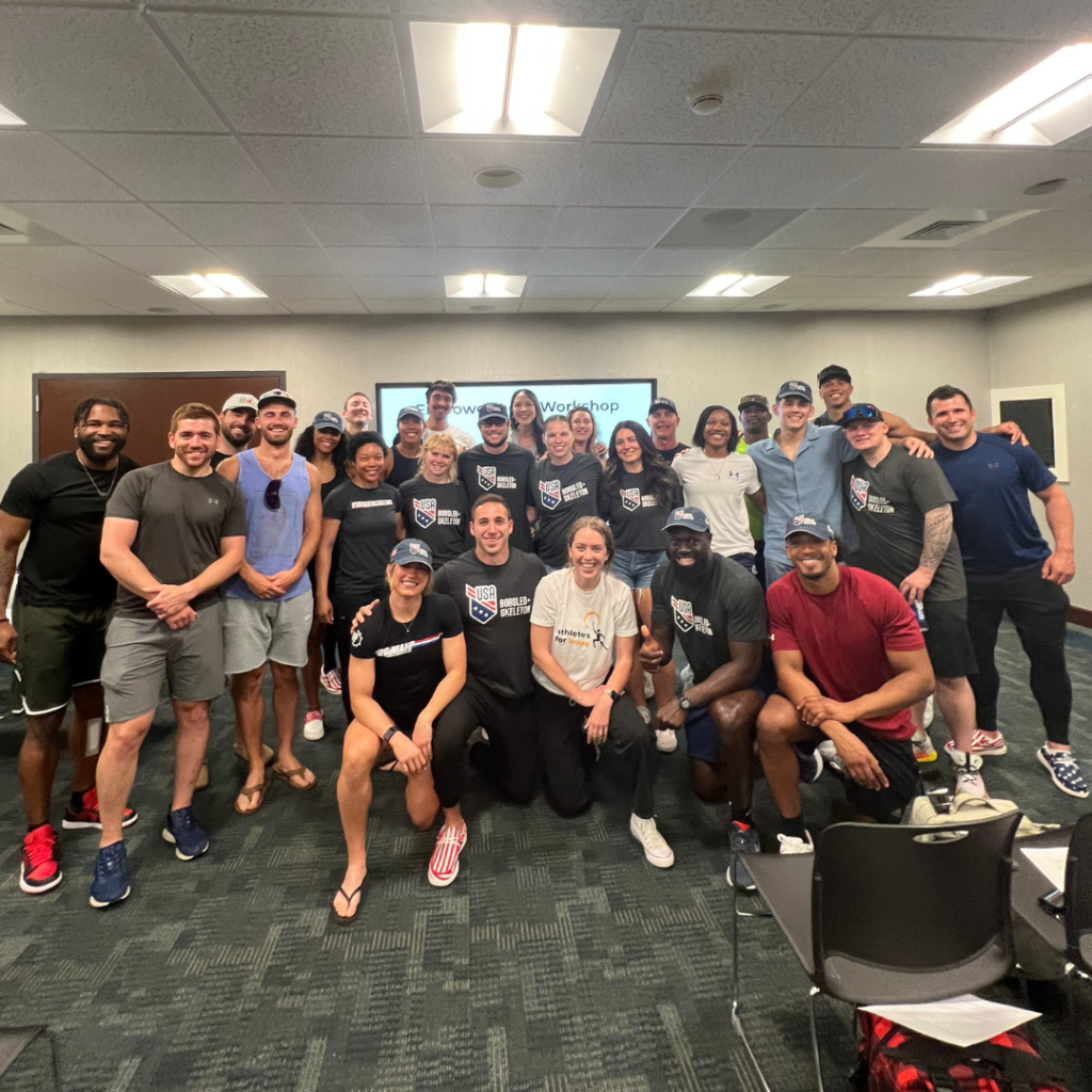 Members of USA Bobsled & Skeleton team pose and smile for a photo with team members for AFH after their Empowerment workshop.