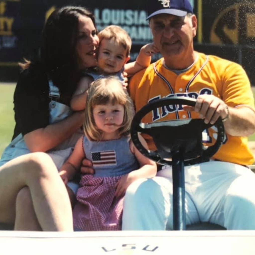 Image of Lori Bertman and her two daughters with Skip Bertman.