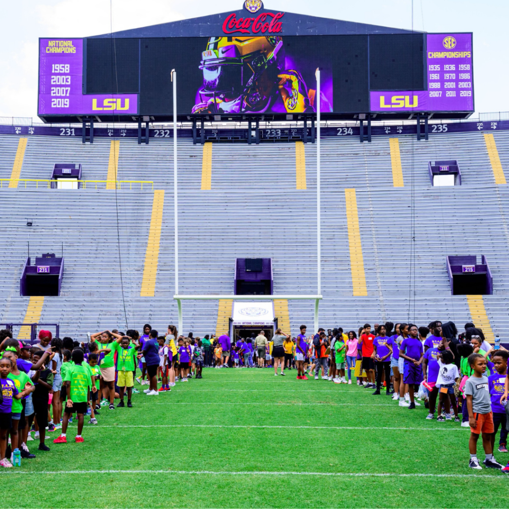 Student-athletes and Beaux Day participants line up on the LSU football field before breaking into their groups.