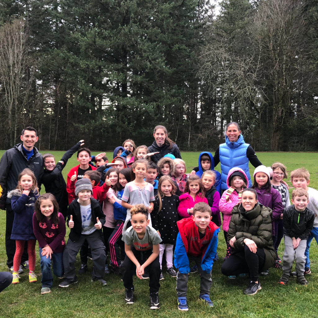 Photo of Shannon Boxx with kids during a soccer clinic