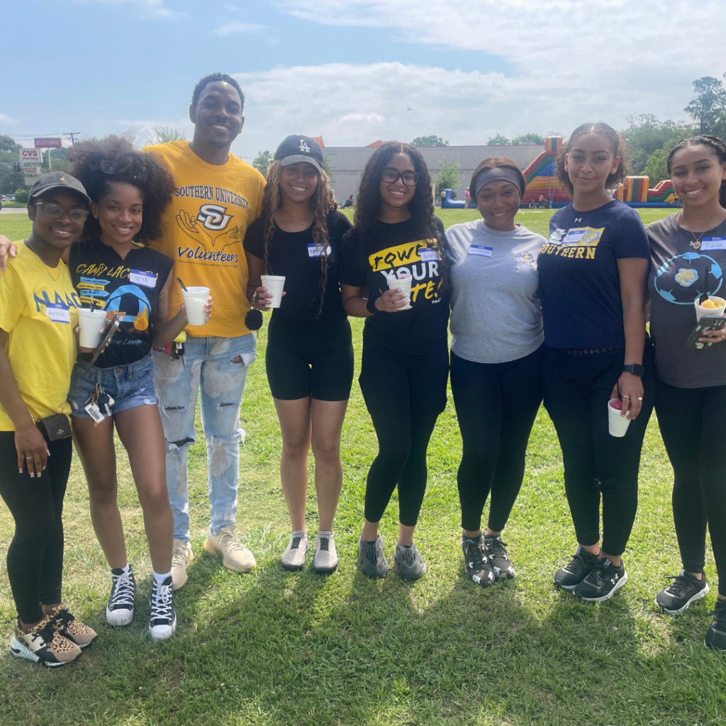 Southern University student-athlete volunteers smile for a photo together. 