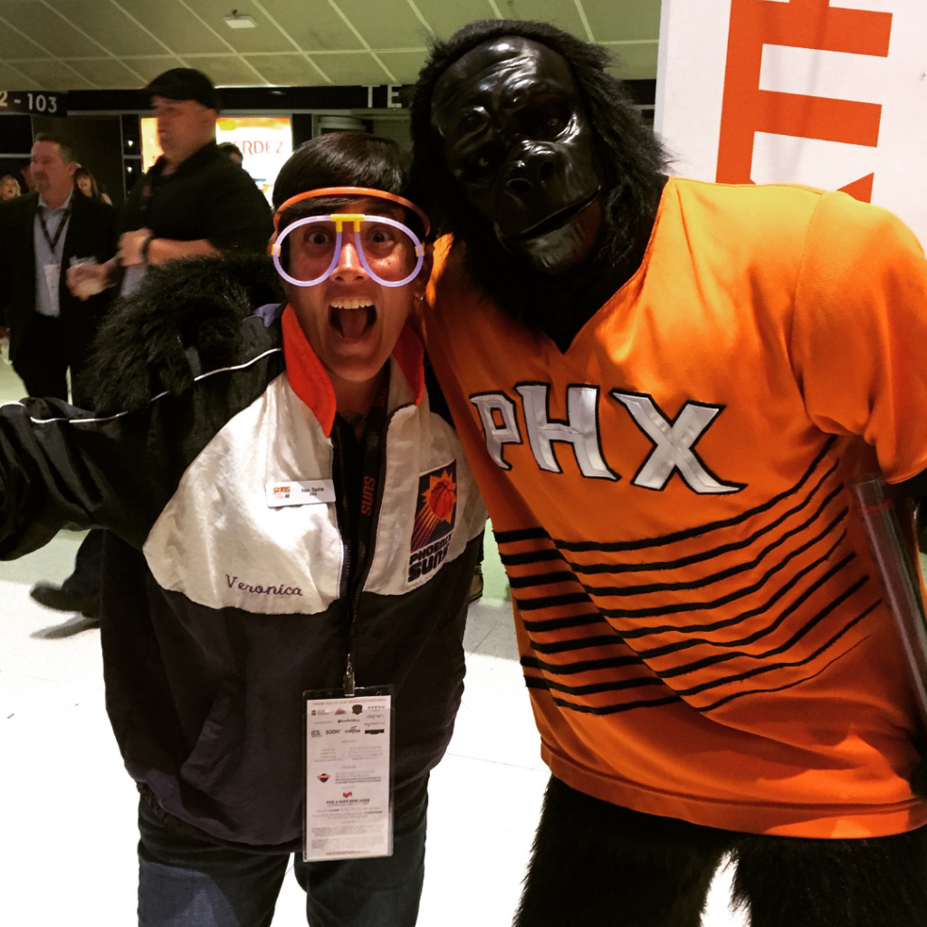 Alex Sachs poses for a photo with the Phoenix Suns mascot, a gorilla, at a Suns 88 event.