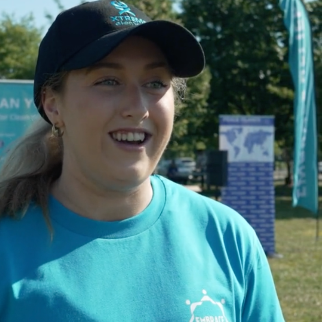 Lauren Brzozowski being interviewed during an Embrace Relief 5k walkathon event.