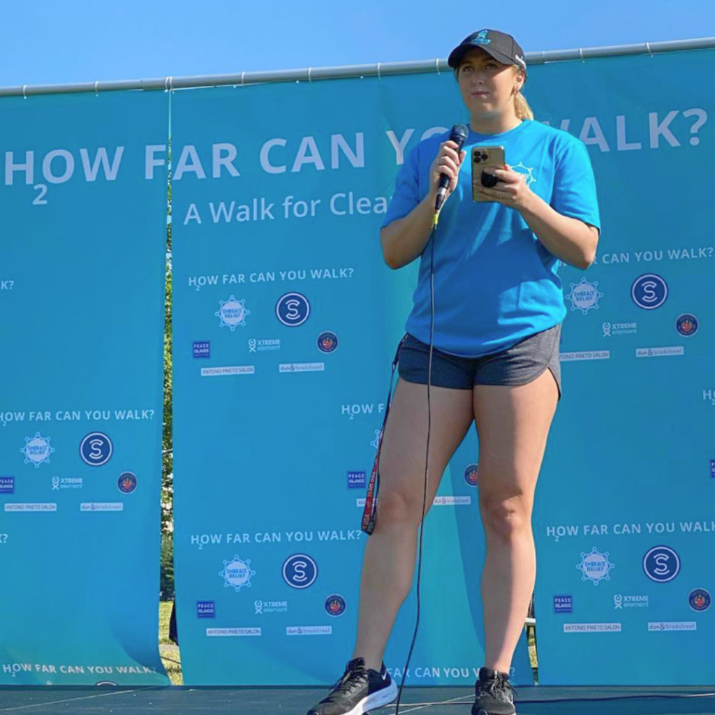 Lauren Brzozowski speaking before an Embrace Relief 5k walkathon event.