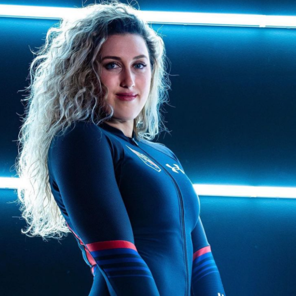 Photo of Lauren Brzozowski smiling softly in her USA bobsled uniform.