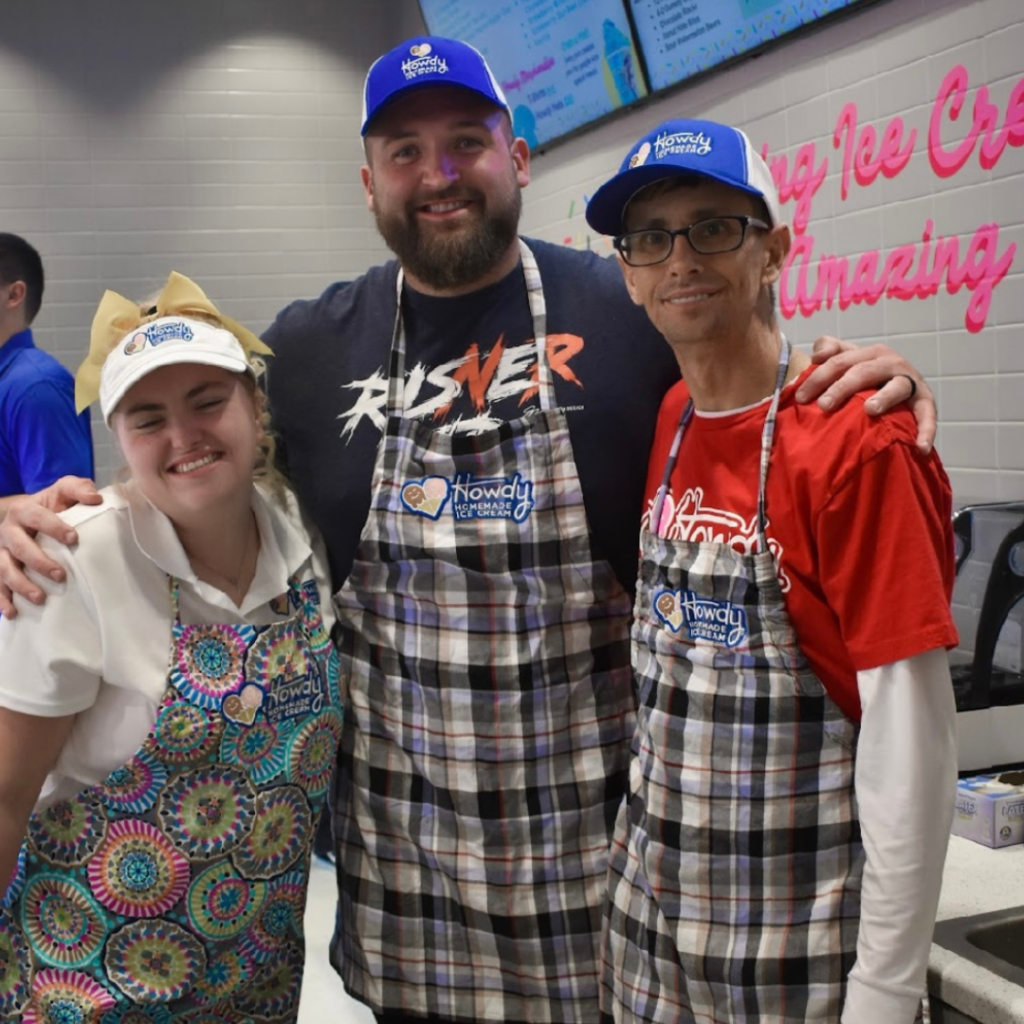 Dalton Risner smiles between two other volunteers.