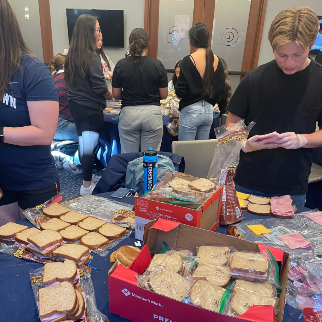 A Georgetown student-athlete prepares a sandwich.