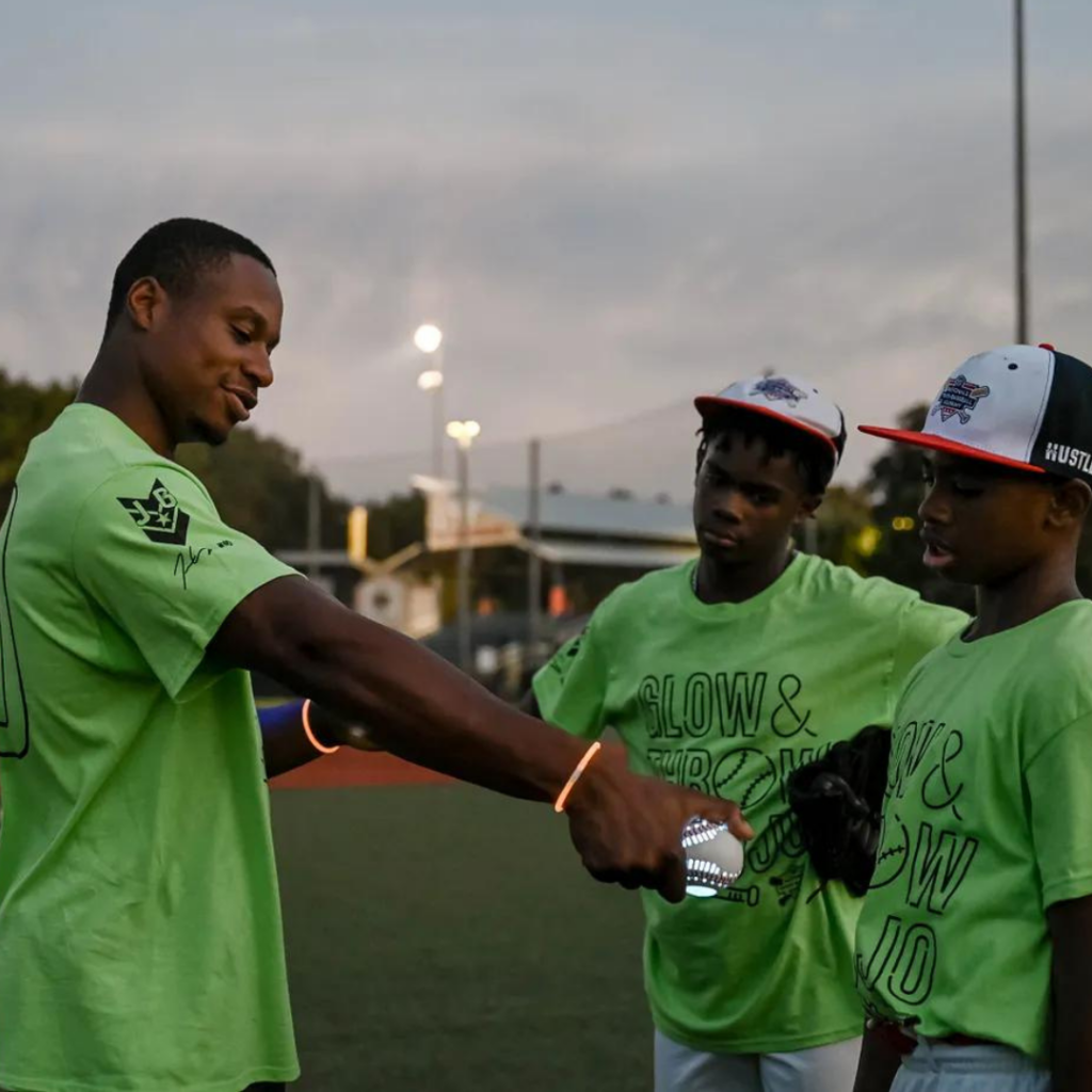 Josiah Gray gives instruction to two Glow & Throw with Jojo participants 