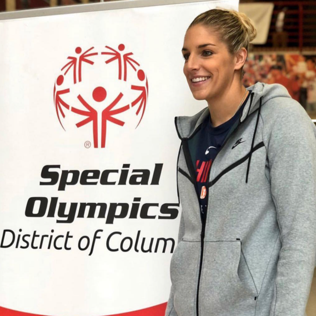 Elena Delle Donne next to a Special Olympics District of Columbia sign.