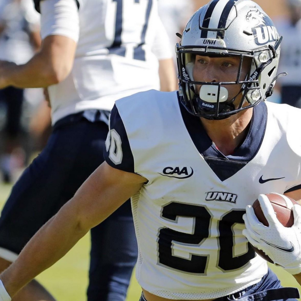 Dylan Laube runs with the football at a University of New Hampshire game.