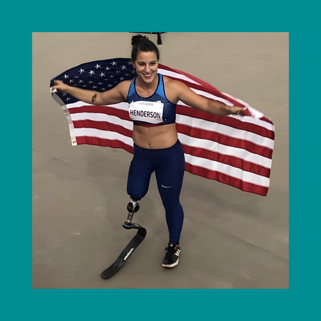 Photo of Lacey Henderson on a teal background. Lacey is standing and holding an American flag behind her, almost like a cape. She is wearing a track outfit with a track and field bib on while looking to her left and smiling.