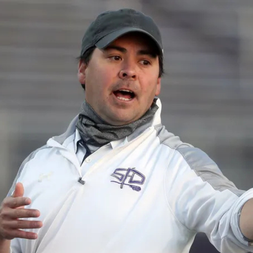 Up close photo of Matt Triplet while coaching lacrosse. 